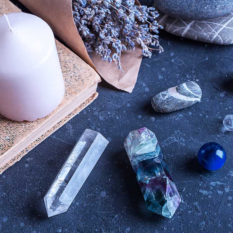 Magic still life with fluorite, quartz crystal and pink candle. Magic rocks for mystic ritual, witchcraft Wiccan or spiritual practice (healing). Meditation reiki. Ritual for love and chakra balance