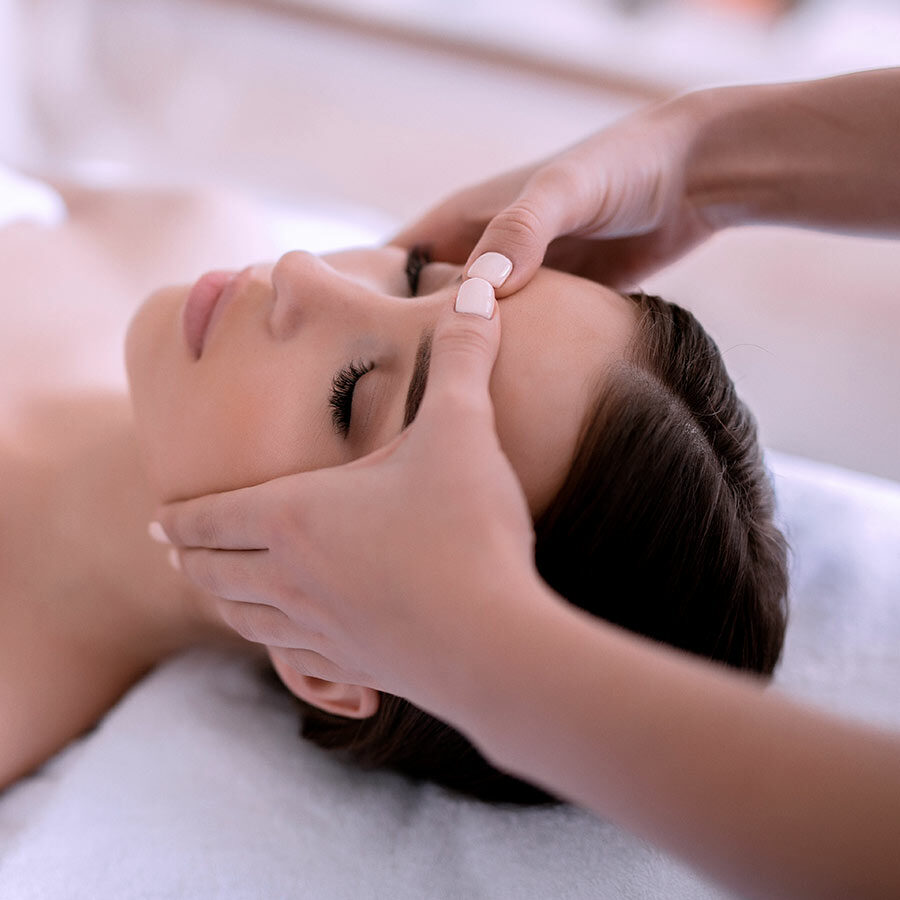 Calm girl having spa facial massage in luxurious beauty salon